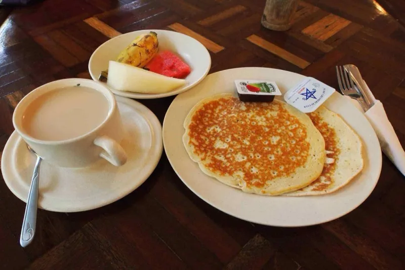 Pancakes with coffee and fresh fruit